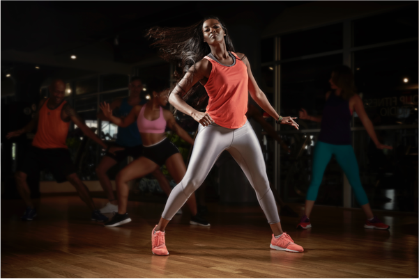 Unrecognizable-athletic-women-doing-stretching-exercises-while-warming-up-at-health-club